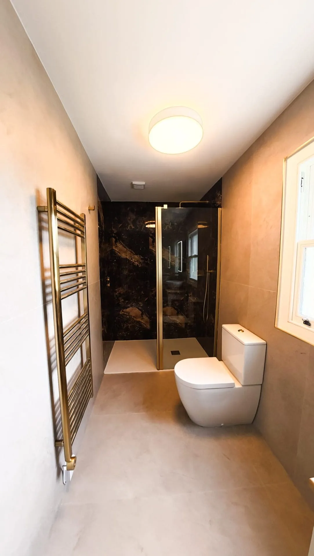 Luxury tiled bathroom with brushed brass