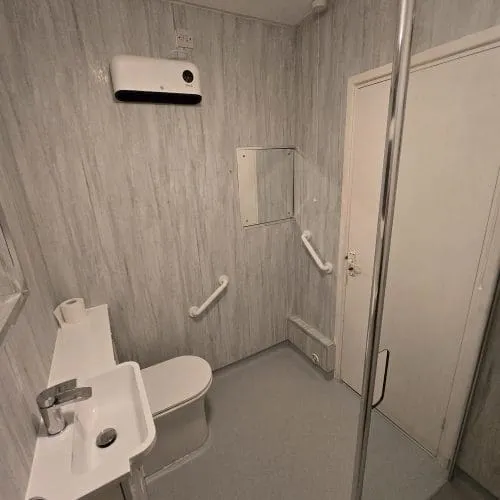 A wet room with non-slip Altro flooring, grab handles, and walk in shower.